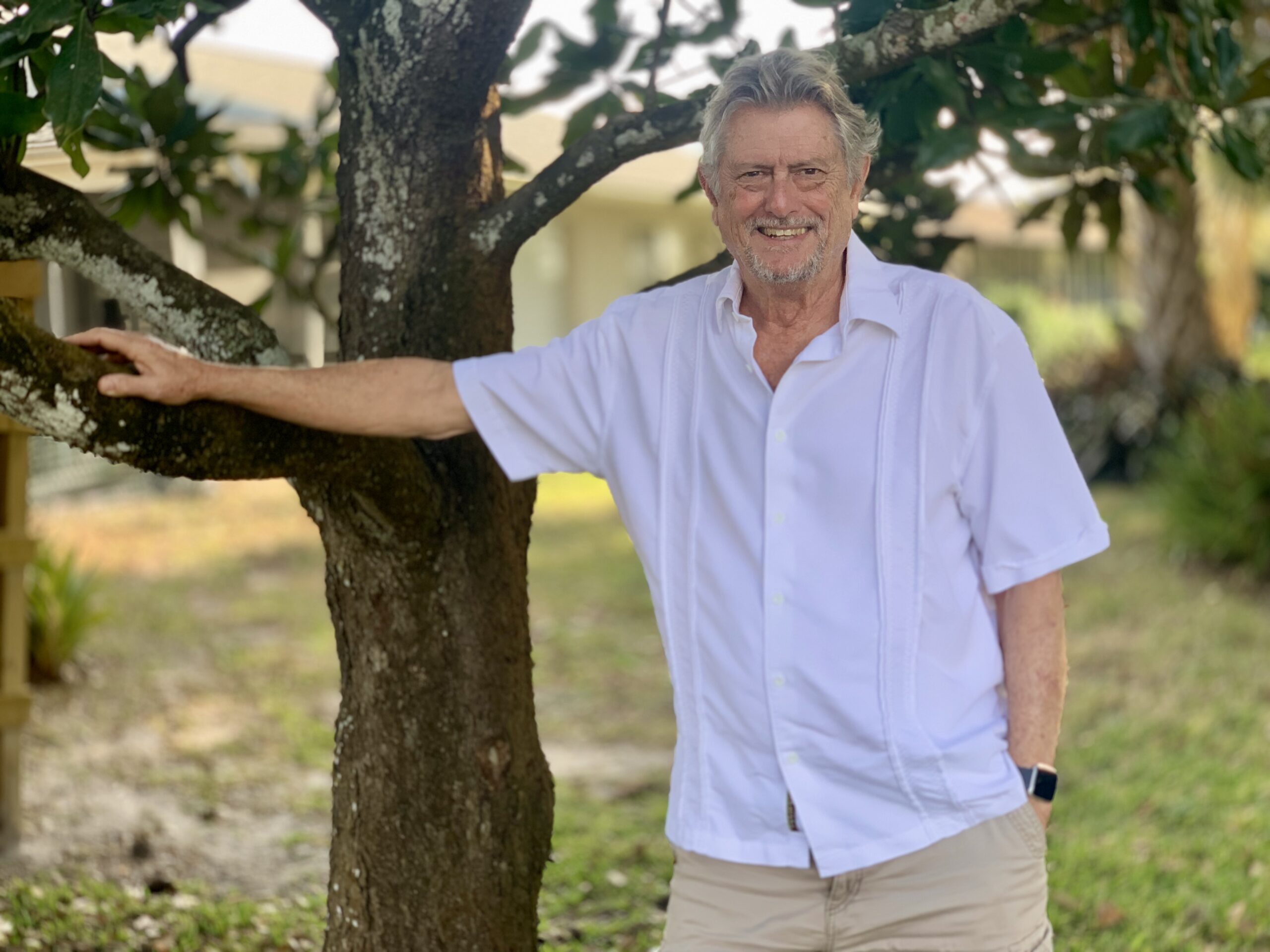 Ed McCarren propped on a tree